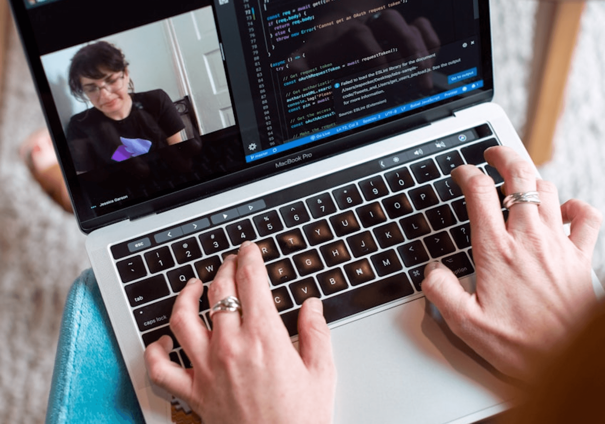A person facing with his laptop coding the website using vscode.
